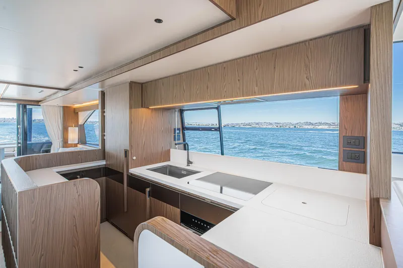 Slide: The Image of Luxurious kitchen interior of 2026 Azimut Fly 72 yacht with ocean view. - 49