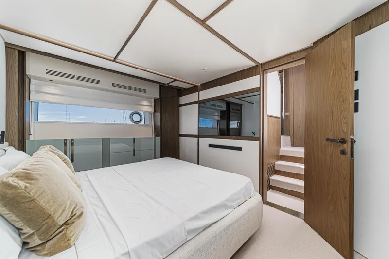 Slide: The Image of Luxurious bedroom interior of 2026 Azimut Fly 72 yacht with modern design and wooden accents. - 54