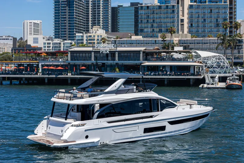 Slide: The Image of 2026 Azimut Fly 72 yacht cruising near urban waterfront with modern buildings. - 6