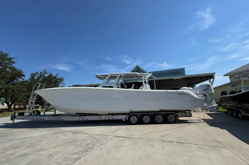 The Image of 2026 Invincible 46 Catamaran on trailer under clear blue sky. - 1