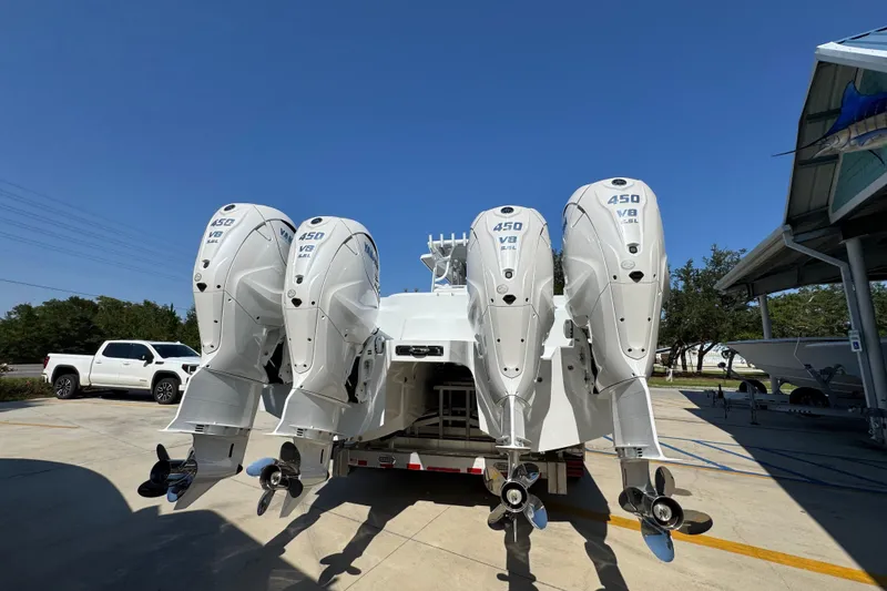 Slide: The Image of 2026 Invincible 46 Catamaran with four powerful 450 V8 engines, parked outdoors. - 15