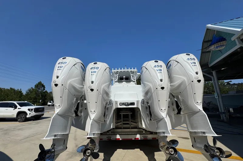 Slide: The Image of 2026 Invincible 46 Catamaran with four powerful 450 V8 engines, parked outdoors. - 16