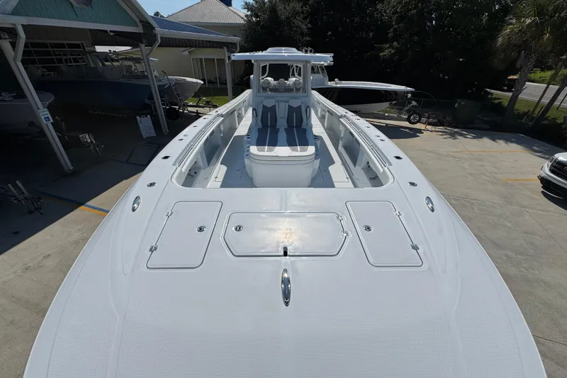 Slide: The Image of 2026 Invincible 46 Catamaran, sleek design, spacious deck, docked at marina. - 20