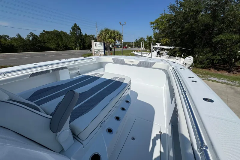 Slide: The Image of 2026 Invincible 46 Catamaran with spacious deck and modern seating, docked outdoors. - 22