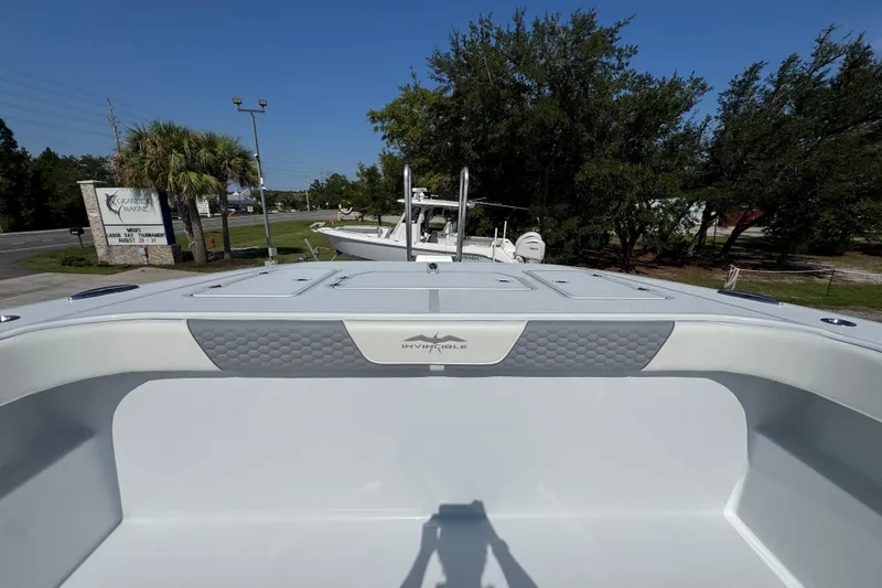 Slide: The Image of 2026 Invincible 46 Catamaran docked at a marina with trees and signage. - 23