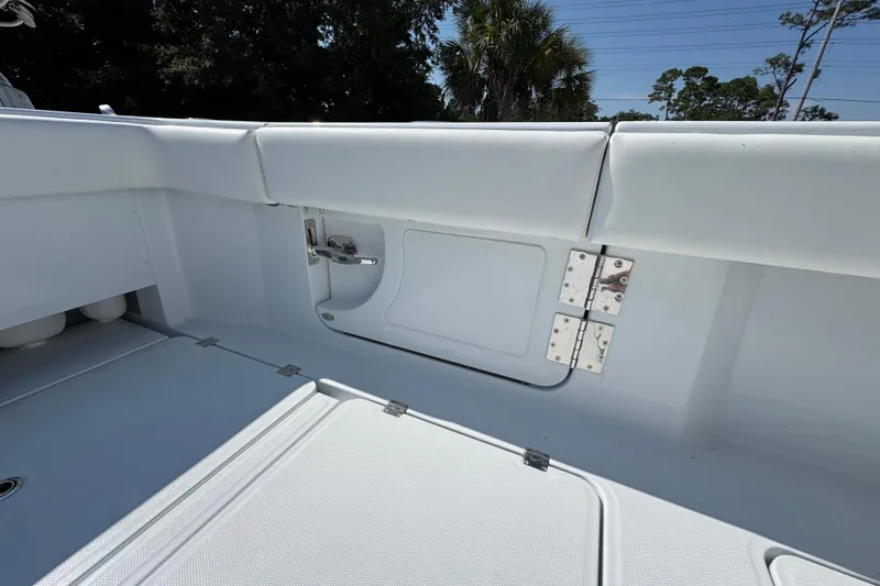 Slide: The Image of Interior view of 2026 Invincible 46 Catamaran, showcasing sleek white seating and storage area. - 45