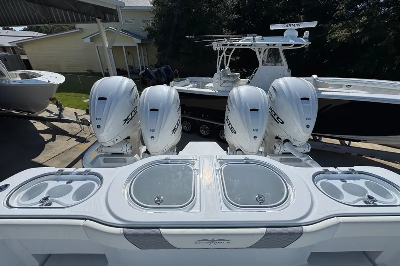 Slide: The Image of 2026 Invincible 46 Catamaran with quad V8 engines, docked alongside other boats. - 49