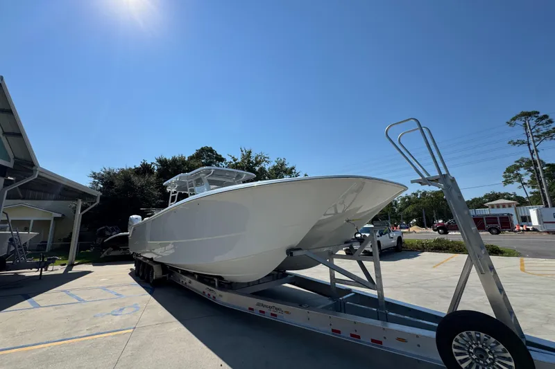 Slide: The Image of 2026 Invincible 46 Catamaran on trailer under clear blue sky. - 8