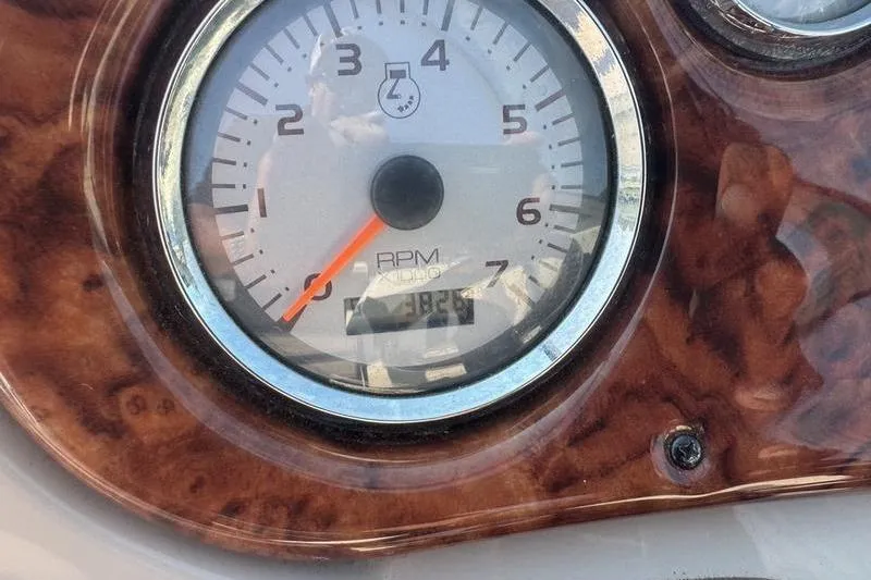 Slide: The Image of Close-up of a 2007 Rinker 282 RPM gauge with wood grain panel. - 10