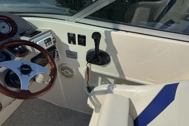 Slide: The Image of 2007 Rinker 282 boat cockpit with steering wheel and control panel. - 11