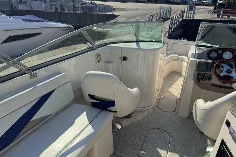 Slide: The Image of 2007 Rinker 282 boat interior with seating and steering console. - 12