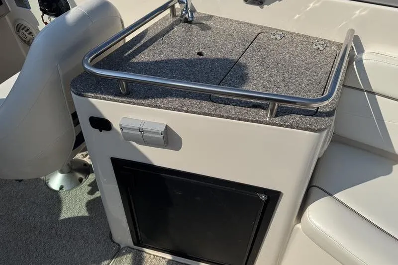 Slide: The Image of 2007 Rinker 282 boat interior with seating and countertop area. - 13