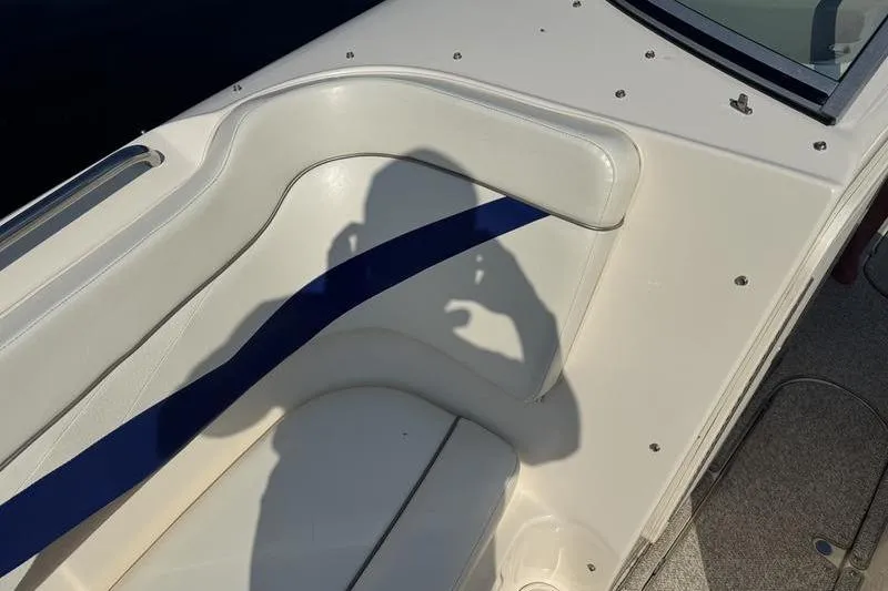 Slide: The Image of 2007 Rinker 282 boat interior with shadow on white and blue seating. - 15