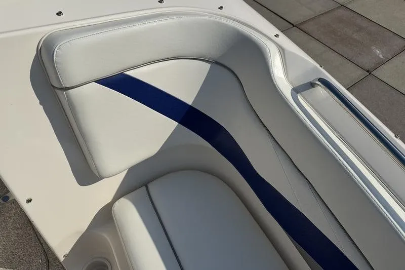 Slide: The Image of 2007 Rinker 282 boat interior with white and blue cushioned seating. - 18