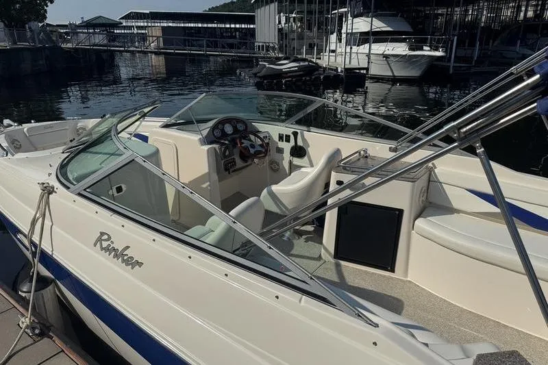 Slide: The Image of 2007 Rinker 282 boat docked at marina, featuring sleek design and spacious cockpit. - 19