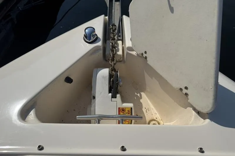 Slide: The Image of Anchor compartment of a 2007 Rinker 282 boat with chain and cleat. - 2