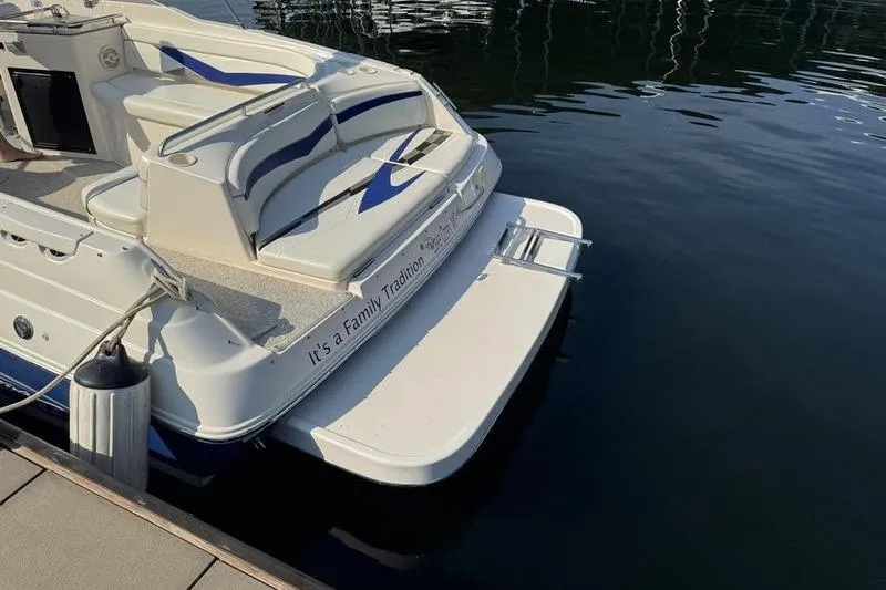 Slide: The Image of 2007 Rinker 282 boat docked, featuring rear seating and swim platform. - 3