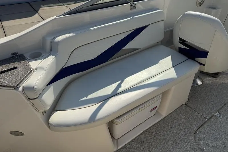 Slide: The Image of 2007 Rinker 282 boat interior with white seating and blue accents. - 5