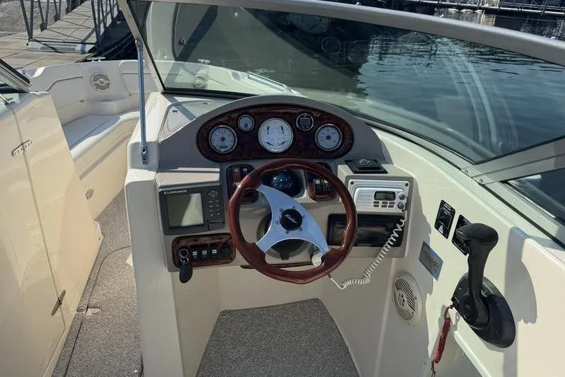 Slide: The Image of 2007 Rinker 282 boat cockpit with steering wheel, gauges, and controls. - 7