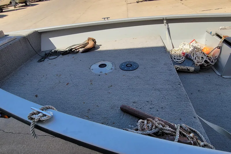 Slide: The Image of 2010 Tracker Guide V 15 Laker boat interior with ropes and anchor on deck. - 10