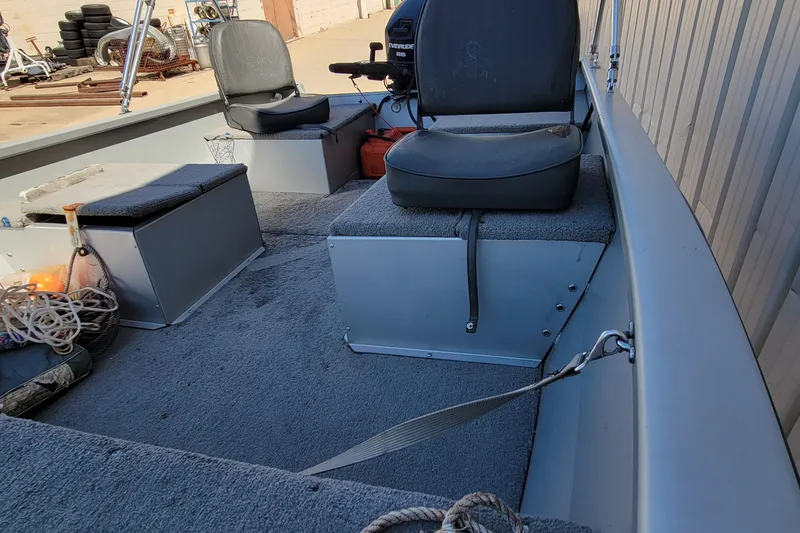 Slide: The Image of Interior of 2010 Tracker Guide V 15 Laker boat with seating and equipment. - 11
