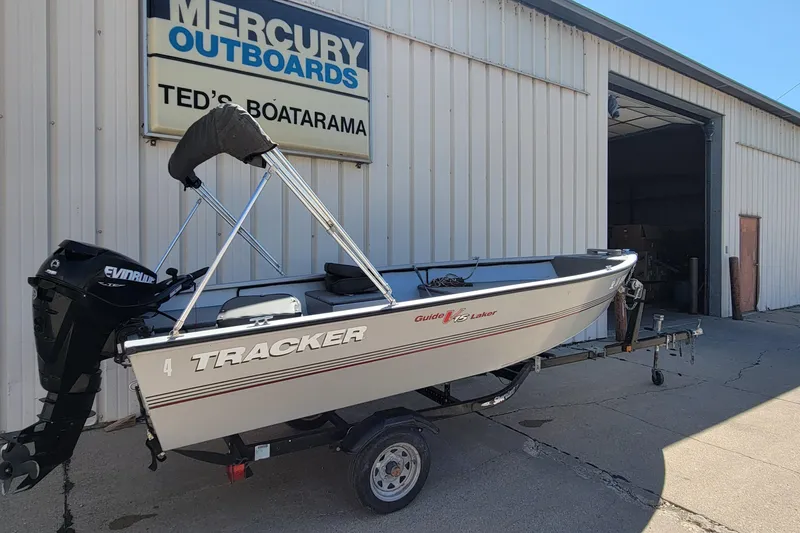 Slide: The Image of 2010 Tracker Guide V 15 Laker boat on trailer outside Mercury Outboards shop. - 2