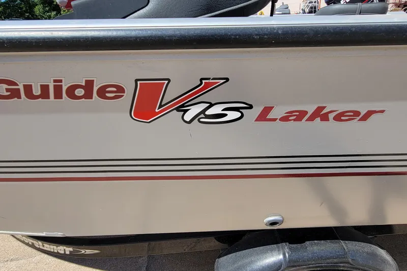 Slide: The Image of 2010 Tracker Guide V 15 Laker boat side view with logo and design details. - 8