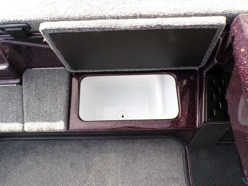 Slide: The Image of Storage compartment in 2025 Phoenix 721 ZXL boat, featuring carpeted interior and open lid. - 20