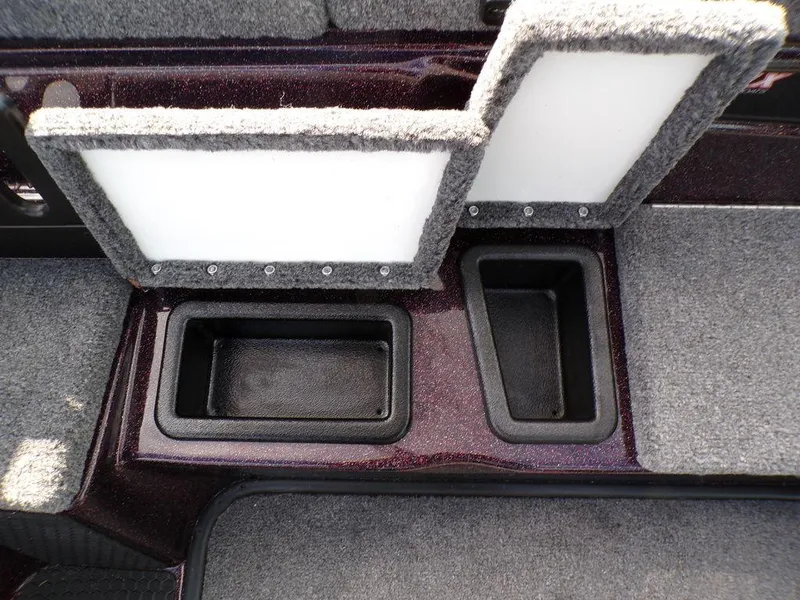 Slide: The Image of Interior storage compartments of 2025 Phoenix 721 ZXL boat, featuring carpeted lids. - 21
