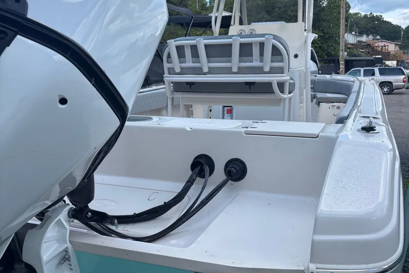 Slide: The Image of 2025 Carolina Skiff 23 Ultra Elite boat interior with motor and seating area. - 3