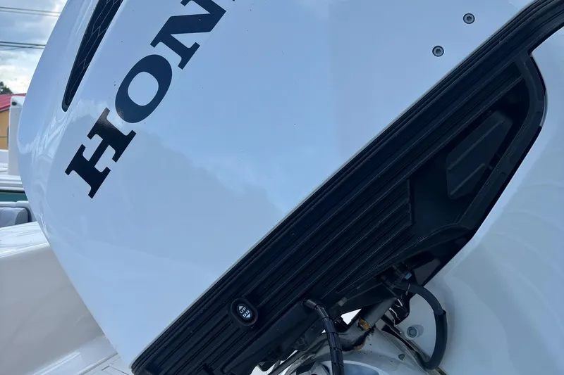 Slide: The Image of Close-up of a Honda outboard motor on a 2025 Carolina Skiff 23 Ultra Elite boat. - 4
