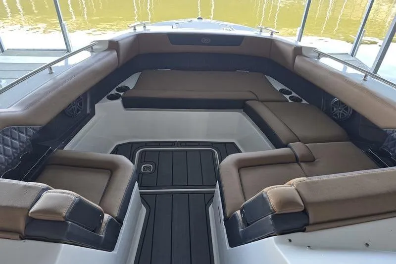 Slide: The Image of 2026 Cobalt R31 boat interior with brown seating and sleek design. - 11