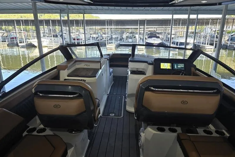 Slide: The Image of Interior view of 2026 Cobalt R31 boat with luxurious seating and modern dashboard. - 2