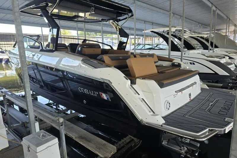 Slide: The Image of 2026 Cobalt R31 boat in marina, featuring sleek design and luxurious seating. - 4