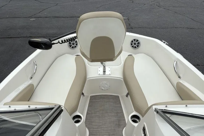 Slide: The Image of 2017 Stingray 191DC O/B boat interior with beige seating and steering console. - 10