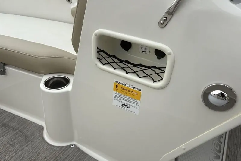 Slide: The Image of 2017 Stingray 191DC O/B boat interior with cup holder and storage net. - 15