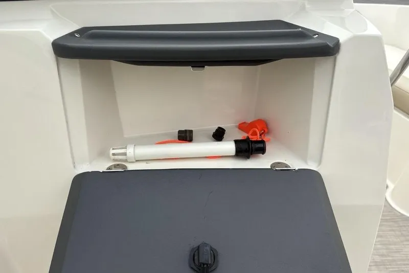 Slide: The Image of Storage compartment in 2017 Stingray 191DC O/B boat with accessories inside. - 18