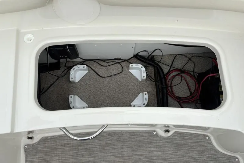 Slide: The Image of Storage compartment of a 2017 Stingray 191DC O/B boat with wiring and brackets. - 22