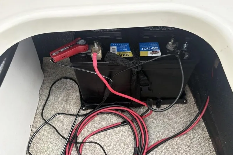 Slide: The Image of Battery compartment of 2017 Stingray 191DC O/B with deep cycle battery and cables. - 23