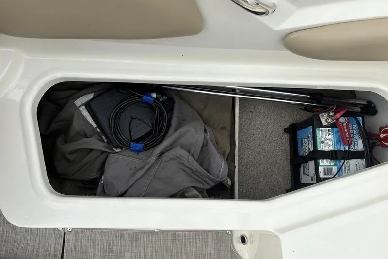 Slide: The Image of Storage compartment of a 2017 Stingray 191DC O/B boat with marine battery and equipment. - 29