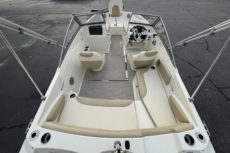 Slide: The Image of 2017 Stingray 191DC O/B boat interior with beige seating and steering console. - 33
