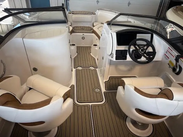 Slide: The Image of 2026 Stingray 211DC boat interior with plush seating and modern dashboard. - 10