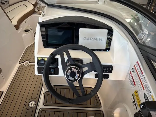 Slide: The Image of 2026 Stingray 211DC boat dashboard with Garmin navigation system and steering wheel. - 11