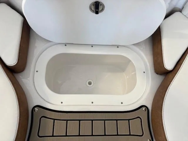 Slide: The Image of 2026 Stingray 211DC boat interior with storage compartment and cushioned seating. - 20