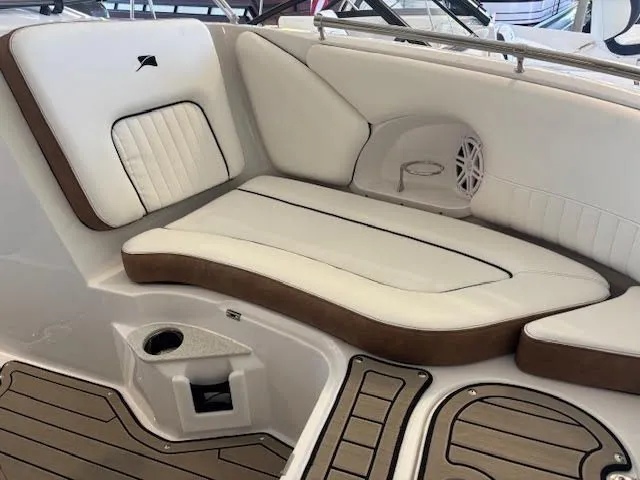 Slide: The Image of 2026 Stingray 211DC boat interior with white cushioned seating and wood accents. - 22