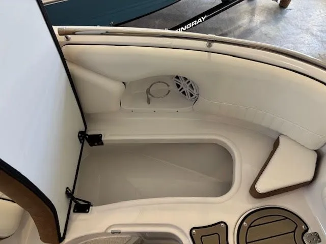 Slide: The Image of 2026 Stingray 211DC boat interior with storage compartment and speaker. - 23