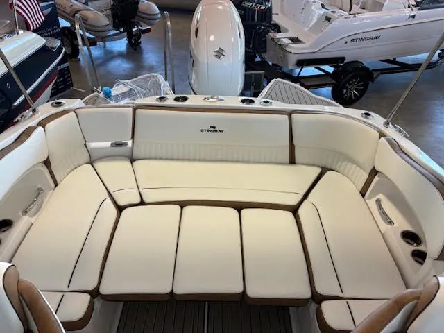 Slide: The Image of 2026 Stingray 211DC boat interior with white cushioned seating and sleek design. - 26