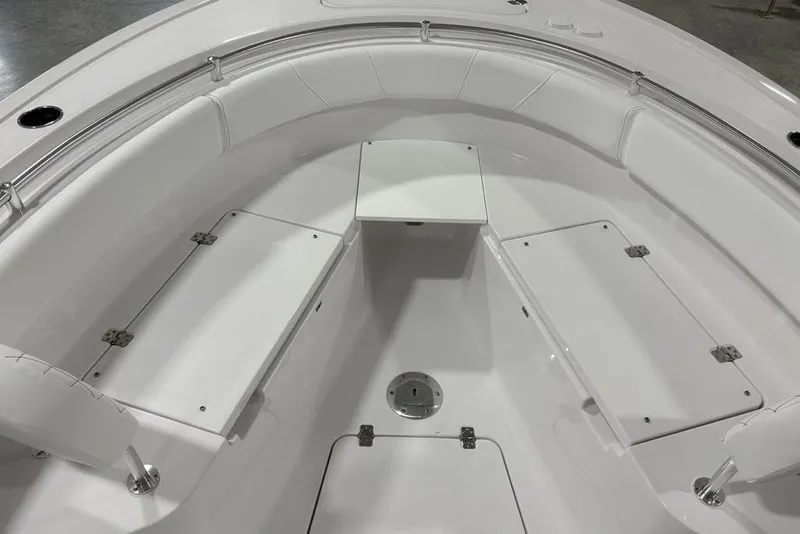 Slide: The Image of 2026 Sportsman Open 232 Center Console boat interior with white seating and storage compartments. - 10