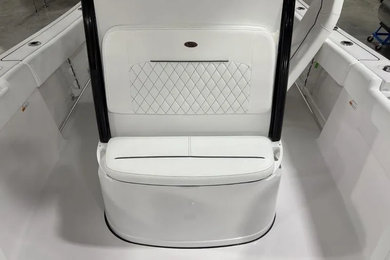 Slide: The Image of 2026 Sportsman Open 232 Center Console boat interior with white cushioned seating. - 11