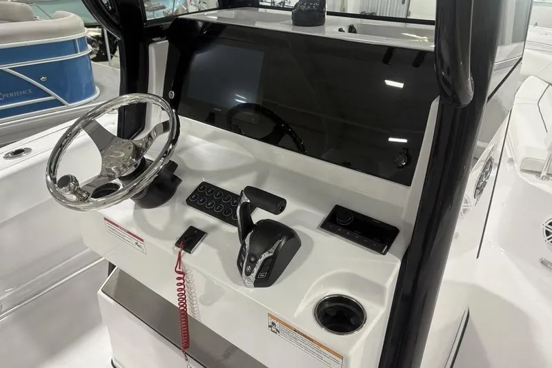 Slide: The Image of 2026 Sportsman Open 232 Center Console boat dashboard with steering wheel and controls. - 15